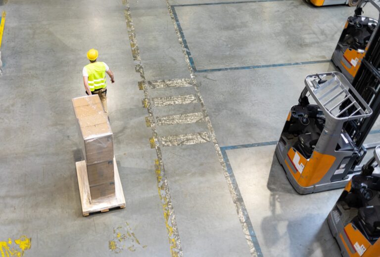 Moving pack boxes using pallet truck in warehouse